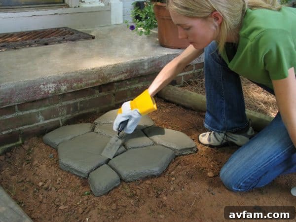 Image depicting the smoothing of rough edges on newly formed concrete pavers before full hardening