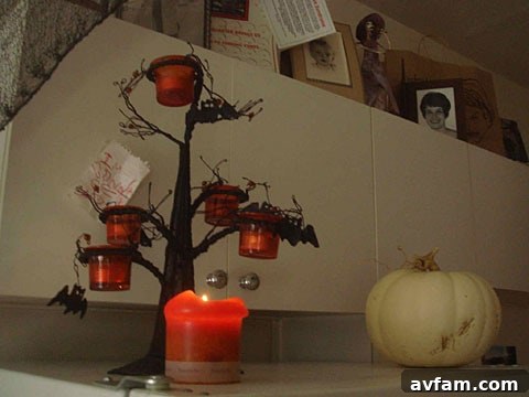 An eerie, dimly lit corridor in Matthew Gray Gubler's home, adorned with vintage Halloween decorations and atmospheric lighting.