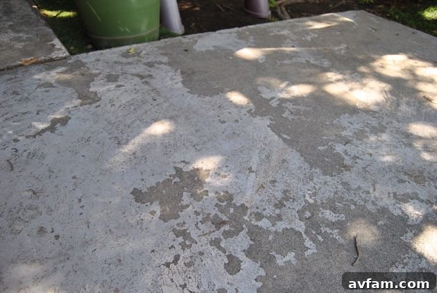 Before shot of a dirty, stained concrete patio surface with visible cracks, highlighting the need for repair