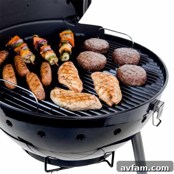 Delicious grilled food, including corn on the cob and various meats, cooked on the Kettleman grill.