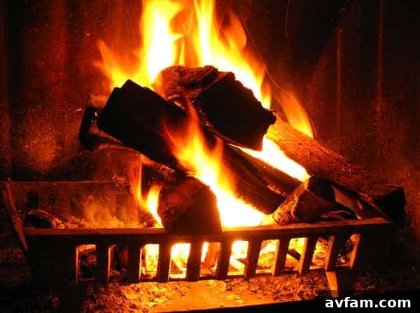 Cozy fireplace with glowing embers and neatly stacked firewood, enhancing a warm living room ambiance