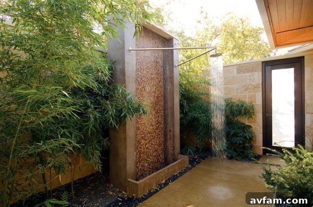 Outdoor shower with stone wall and elegant chrome fixtures