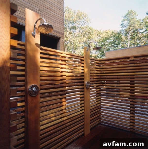 Outdoor shower with wooden privacy screen and overhead rainfall showerhead