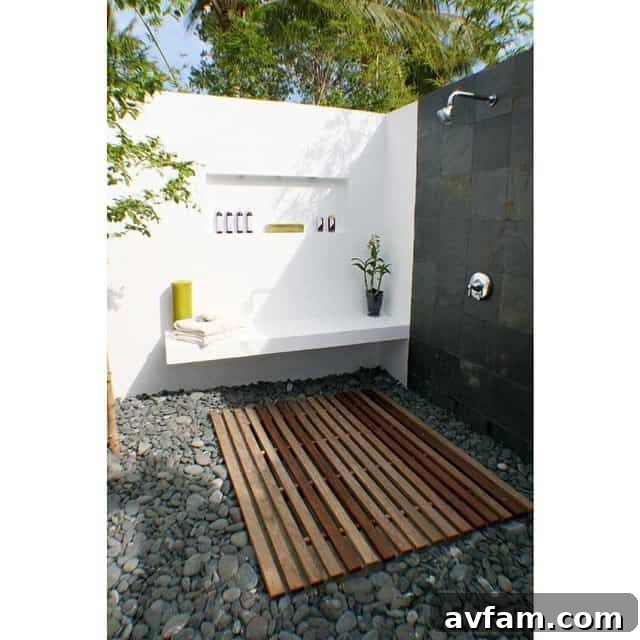 Minimalist outdoor shower with dark wood panel and simple fixtures