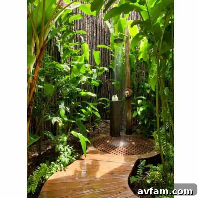 Outdoor shower with natural stone walls and lush plant surroundings
