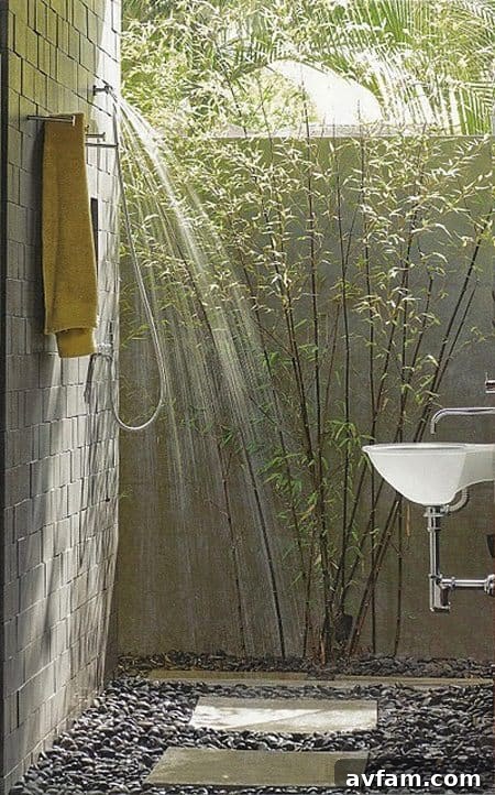 Outdoor shower with slatted wood walls and rock base