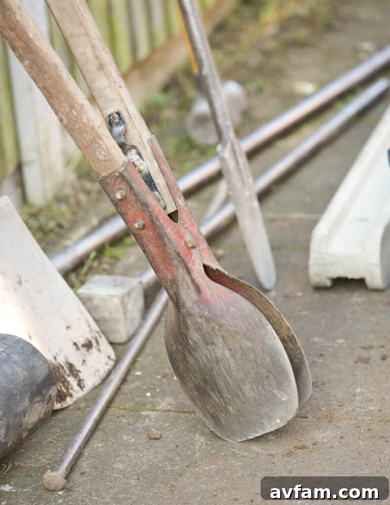Close-up of a posthole digger in action