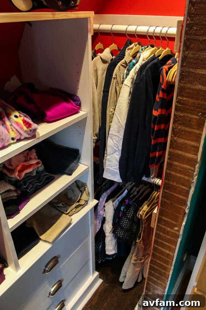 Close-up of an organized kids' closet hangbar showcasing neatly hung clothes and space-saving techniques.