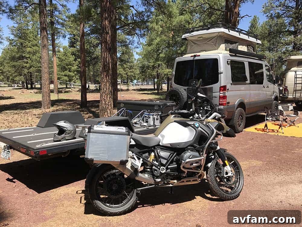 A well-appointed campsite at Overland Expo, featuring multiple tents, awnings, and a fire pit, showcasing the community aspect.