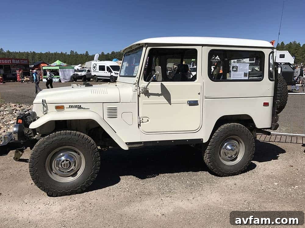 A gray Land Rover Defender 110, an iconic overlanding vehicle, parked among other rigs at the expo.