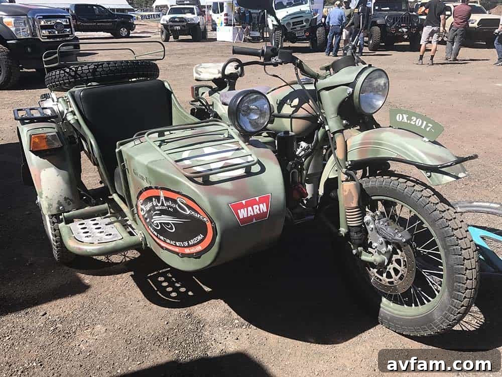 A green Jeep Wrangler, equipped for serious rock crawling and off-road adventures, at Overland Expo.