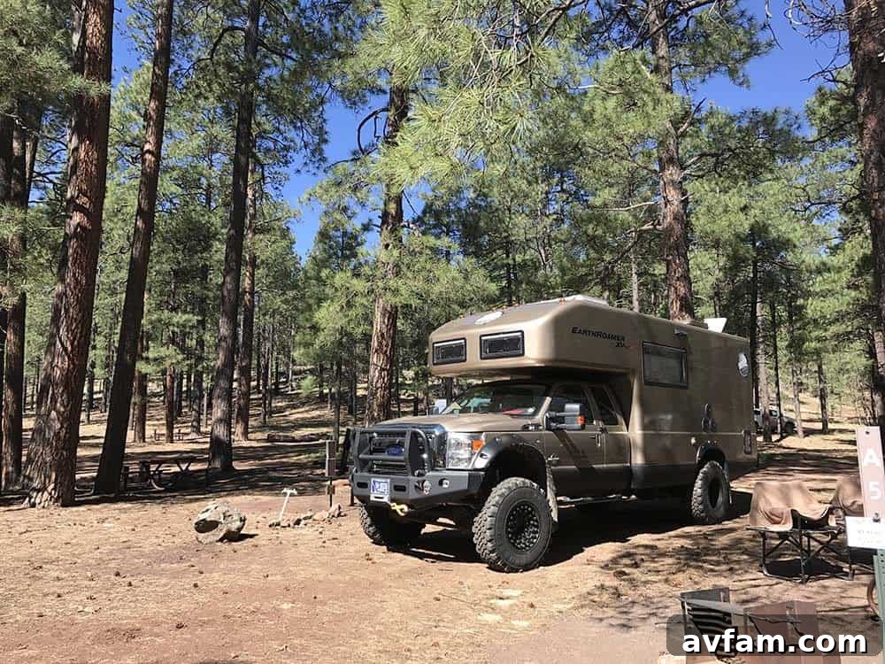 A white overland truck with a unique custom camper, designed for comfort and capability in remote settings.