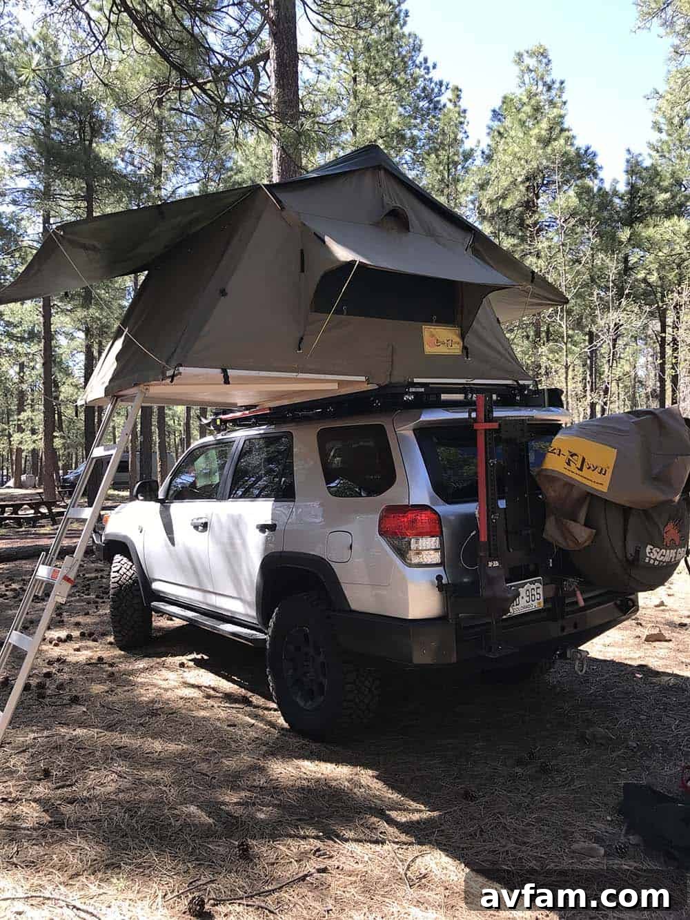 A black Nissan Titan XD Project Basecamp, showcasing its extensive factory-supported overlanding modifications and gear.