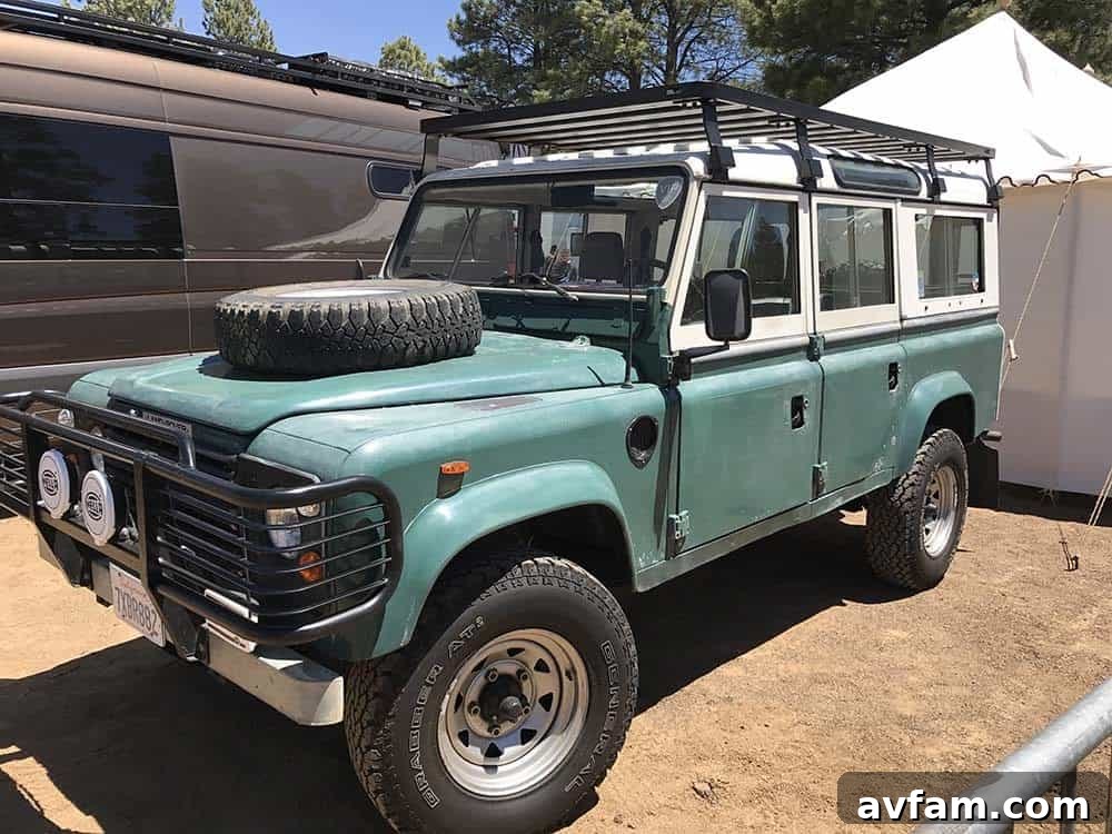 A fleet of classic Land Rover Defender 110s parked at Overland Expo, showcasing their rugged beauty and overlanding capabilities.