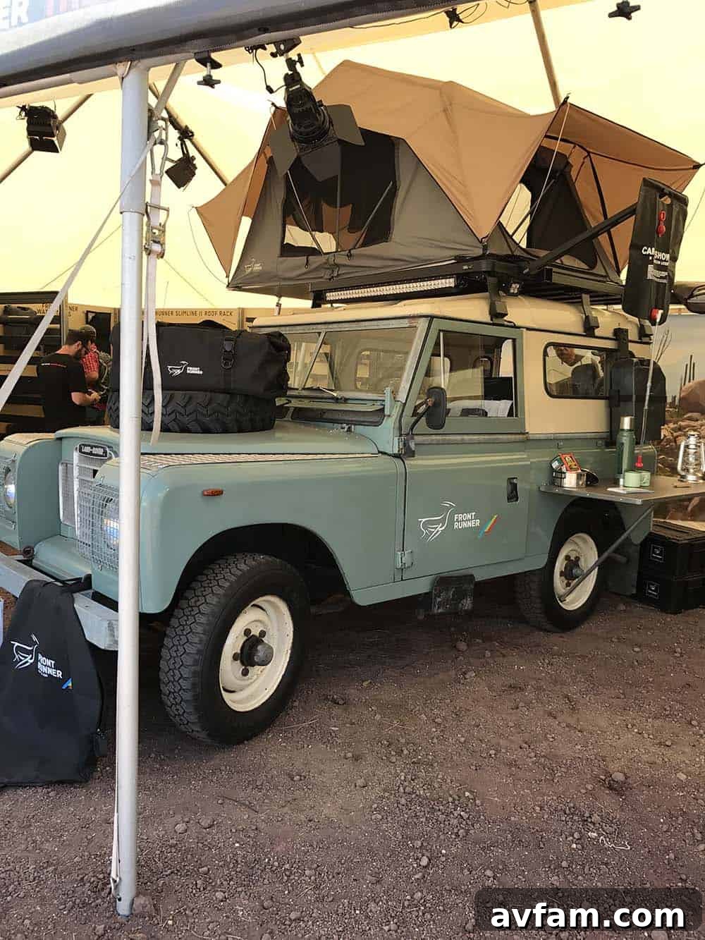 A Land Rover Discovery, modified for overlanding, featuring a rooftop tent and storage boxes, ready for adventure.