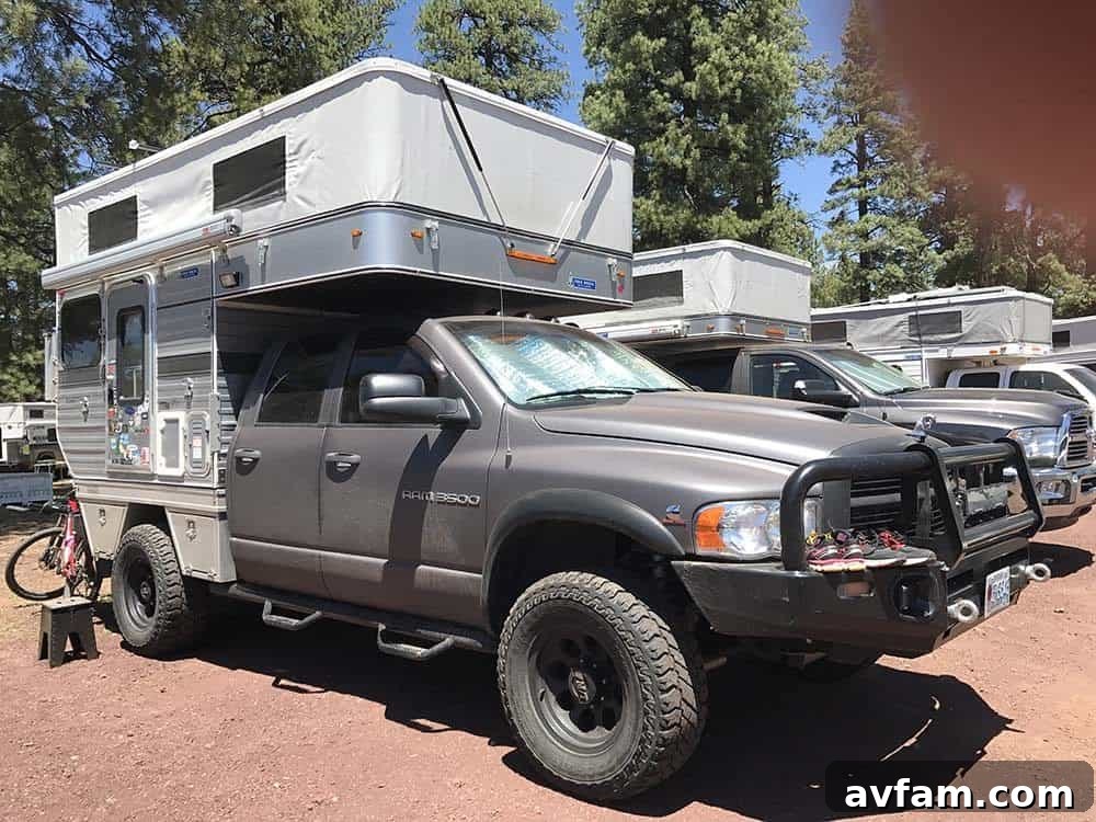 A highly modified white Ford F-Series truck, built for serious off-road expeditions, featuring large tires and a custom bed setup.