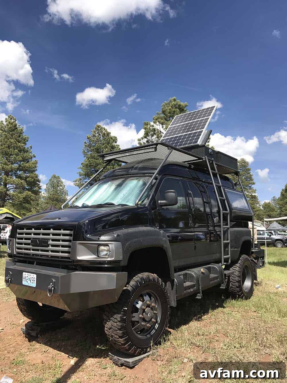 A white Toyota Tacoma pickup truck with a minimalist bed camper shell, perfect for quick overnights and stealth camping.