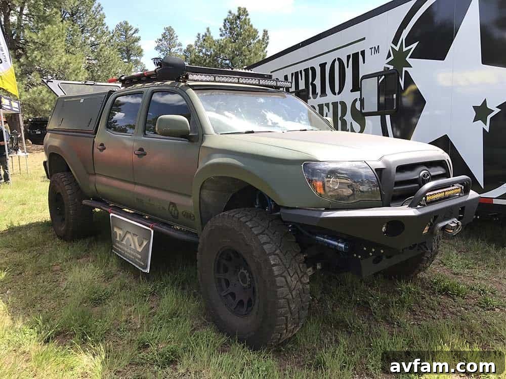 A custom-built overland trailer, designed to be rugged and highly functional, with multiple storage compartments.
