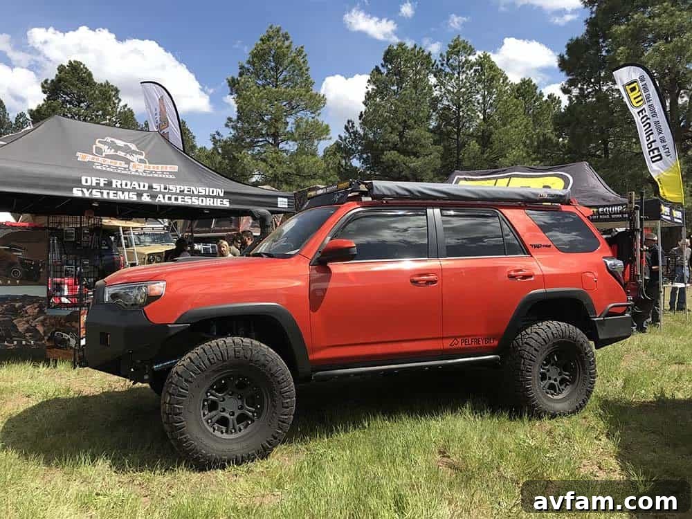 A black Toyota Land Cruiser with a roof rack and auxiliary lights, ready for desert adventures.