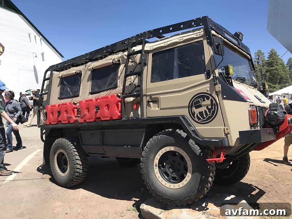 A classic military-style off-road vehicle, possibly a Pinzgauer, equipped for expeditionary travel, at Overland Expo West.
