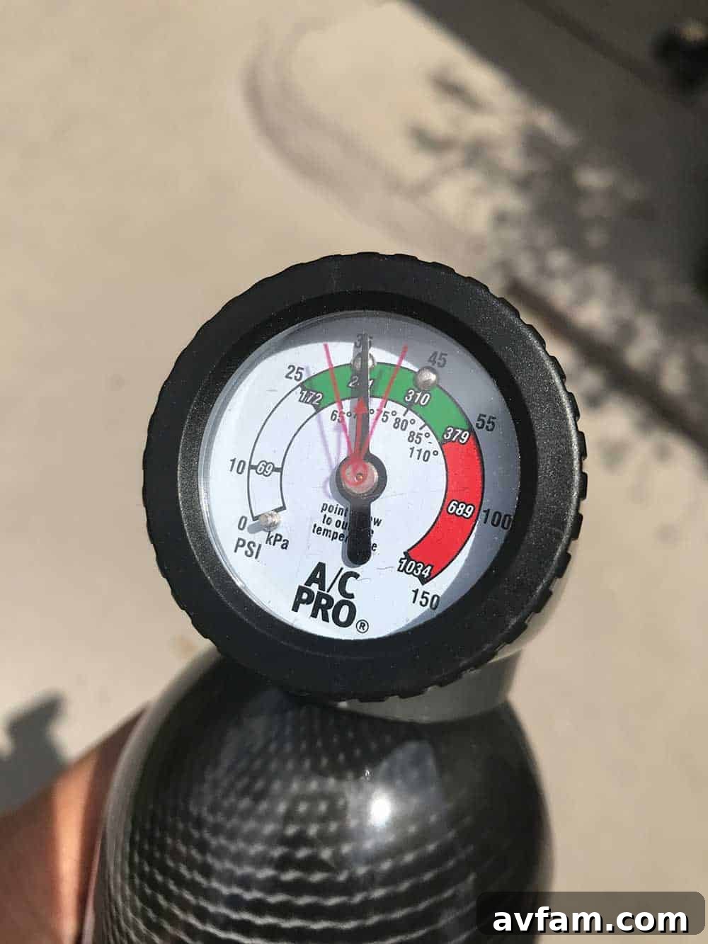 Step 3: Check the Gauge and achieve desired pressure A/C Pro gauge showing pressure in the green range after successful recharge.