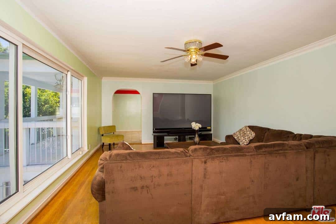 Before painting: A cluttered room with old, dark yellow walls and traditional furniture