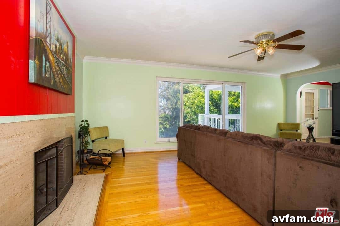 Before painting: Living room corner with heavy drapes and dark, textured walls