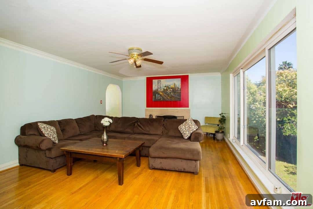 Before painting: Traditional living room with a mix of colors and outdated furnishings