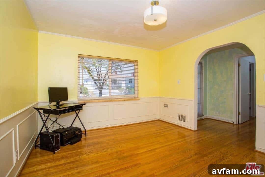 Before painting: An outdated bedroom with pale green walls and traditional decor