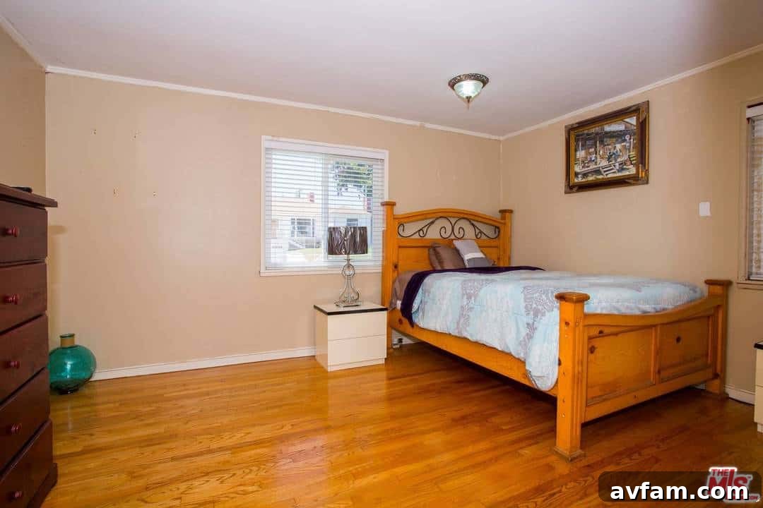 Before painting: A view into a dimly lit room with mismatched colors and old flooring