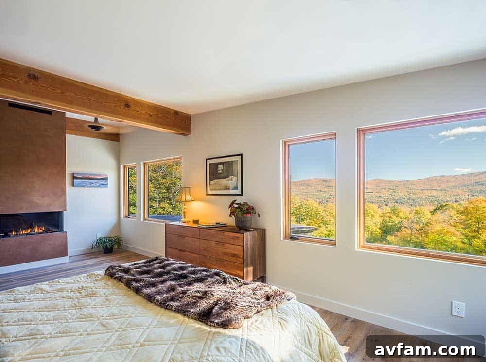 Living room with a large sofa and exposed timber beams, offering mountain views