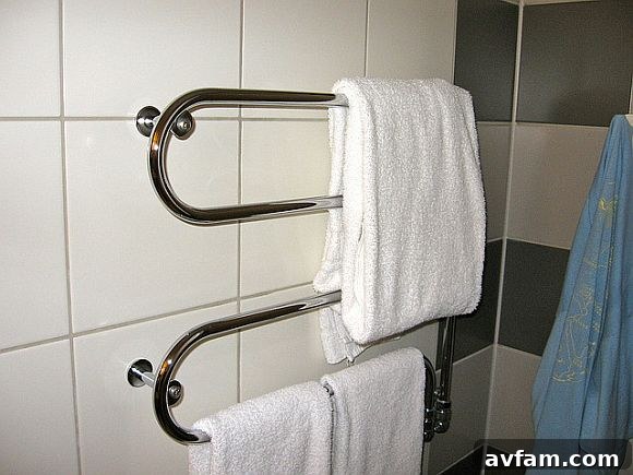 Sleek Heated Towel Rack for Ultimate Comfort Modern heated towel rack in a spa-like bathroom setting