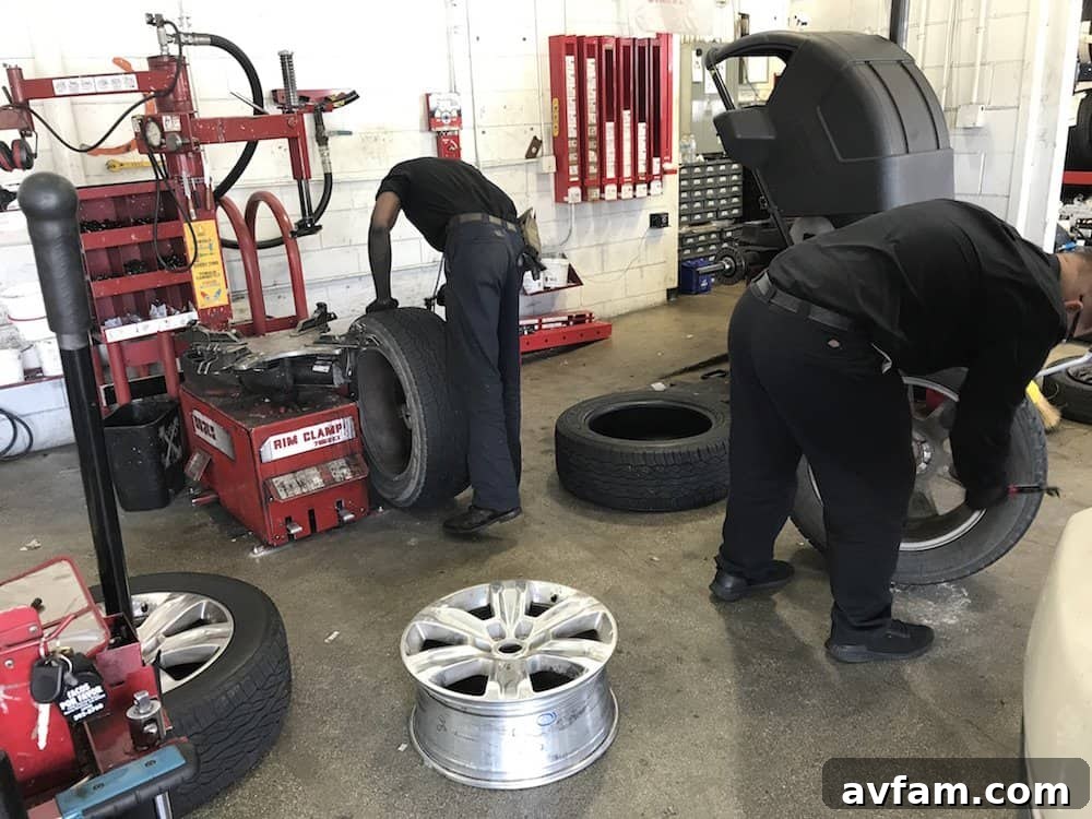 America's Tire technician installing Goodyear Wrangler UltraTerrain AT