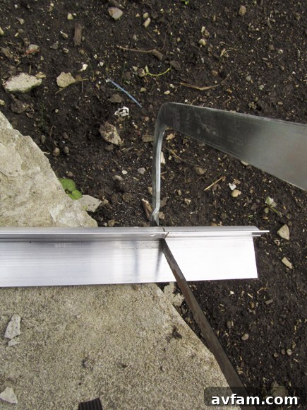 Cutting Metal Weatherstripping Close-up of a hacksaw being used to precisely cut the metal bracket of new weatherstripping.