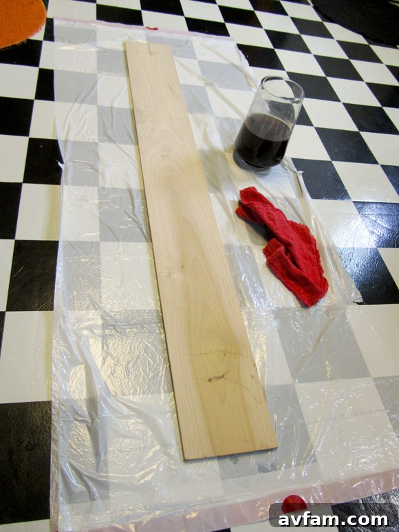 Initial stage of the DIY giant ruler project, featuring a raw, sanded wooden plank ready for the first steps of preparation and customization. The wood is clean and free of major imperfections.
