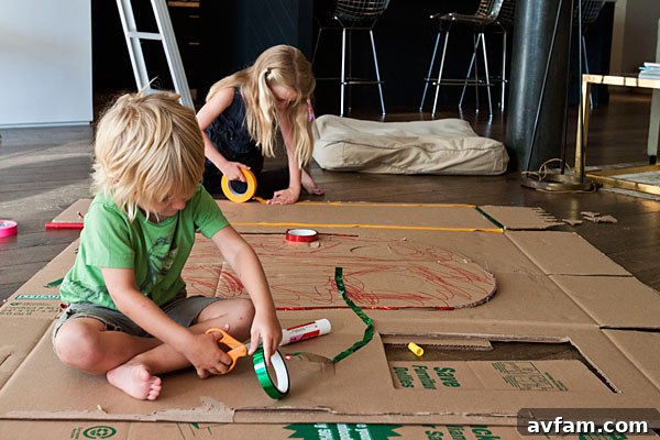 Creative Cardboard Decorating Projects for Kids Two joyful children decorating cardboard cutouts with colorful markers and glitter, showcasing imaginative and accessible crafting.