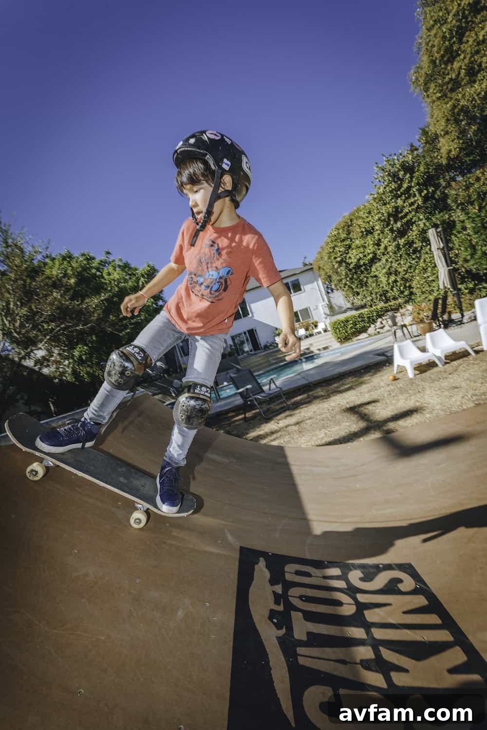 Kids playing on the newly built backyard skate ramp