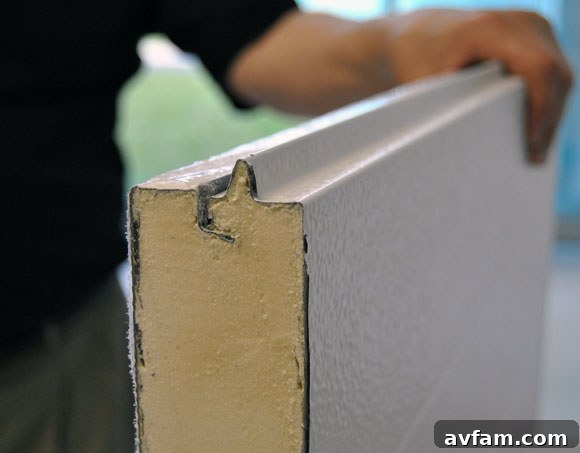 Polystyrene insulation being fitted into a garage door panel.