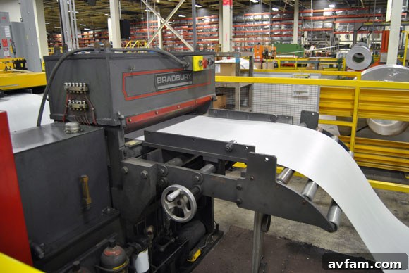 Machinery smoothing and preparing steel panels for shaping.