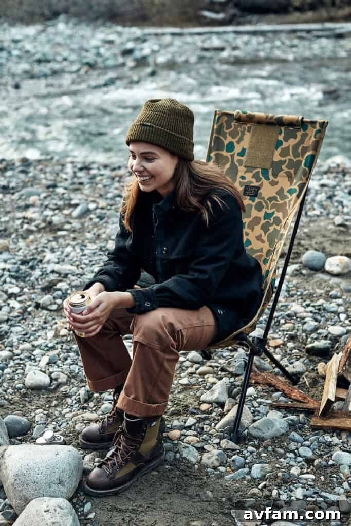 Filson Helinox Tactical Sunset Chair in a scenic outdoor setting by a river