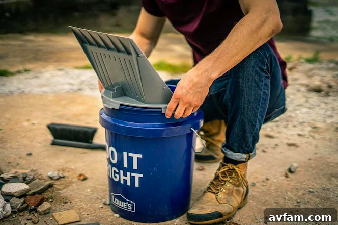 A user demonstrating the hands-free sweeping capability of the Quiklid bucket scoop, efficiently gathering debris into the bucket.