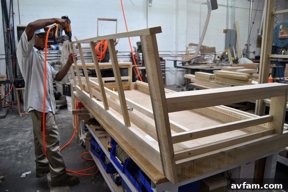 Thrive Furniture craftsman using a nailer on a sofa frame