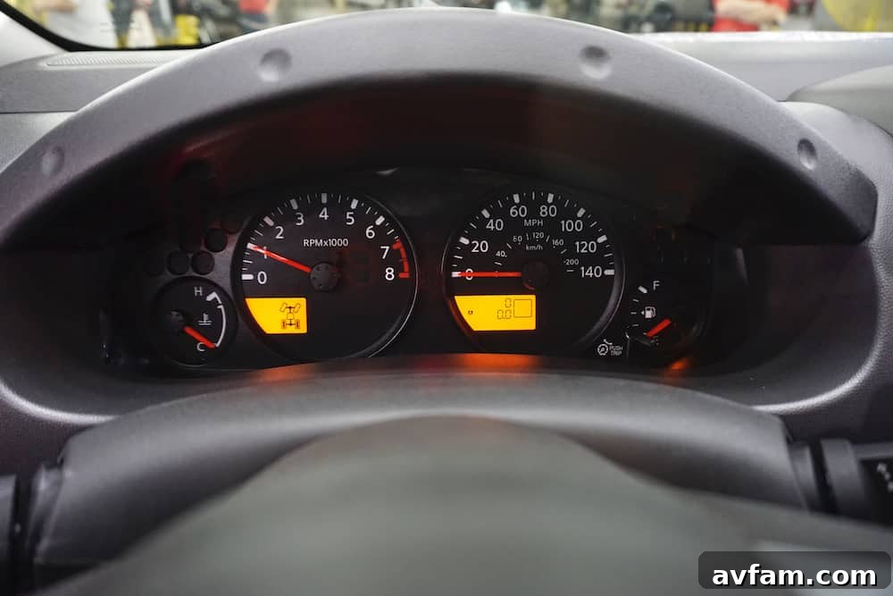 A mechanic’s hands carefully inspect an engine component, illustrating the importance of regular vehicle maintenance, especially for achieving high mileage like a million miles on a Nissan Frontier.