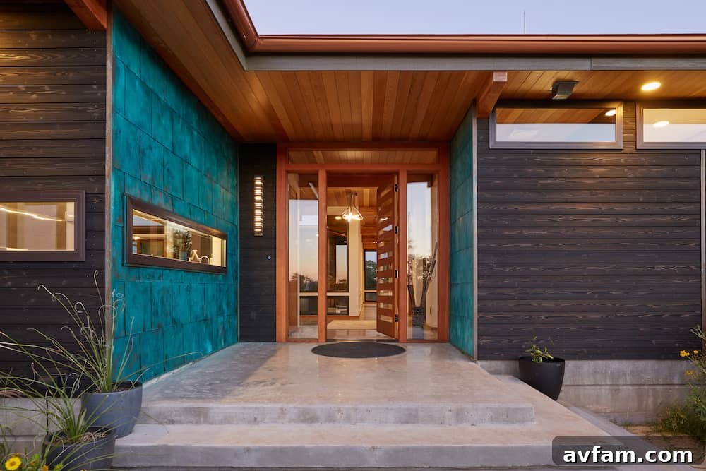 Residential exterior featuring dark charred wood and a minimalist landscape.