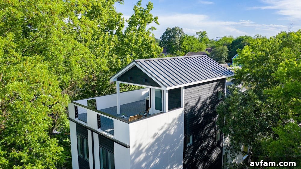 Modern home exterior featuring charred wood siding and large windows, reflecting nature.
