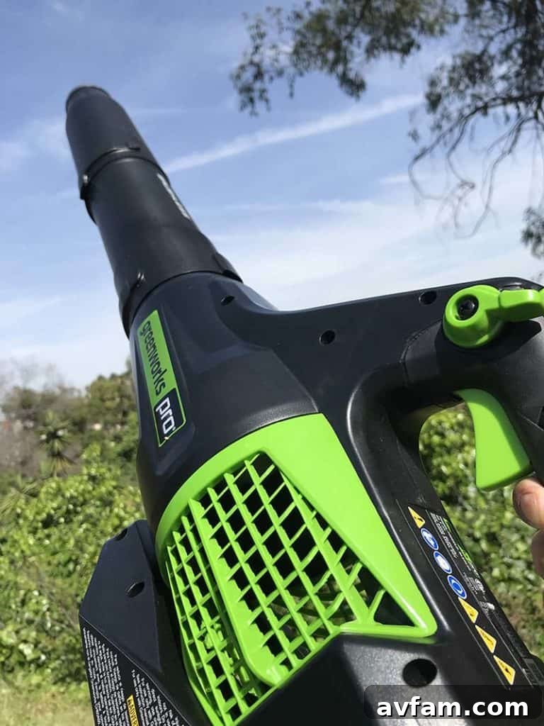 Unlock the Versatility of Your Leaf Blower: Beyond Just Leaves A person using a leaf blower to clear debris from a garage floor.