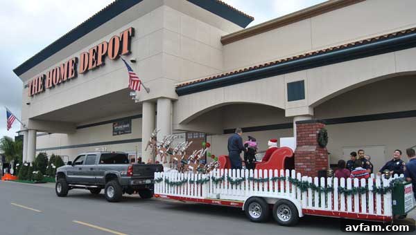 Santa Claus arrives at Home Depot to promote fire safety, greeted by excited children and community members.