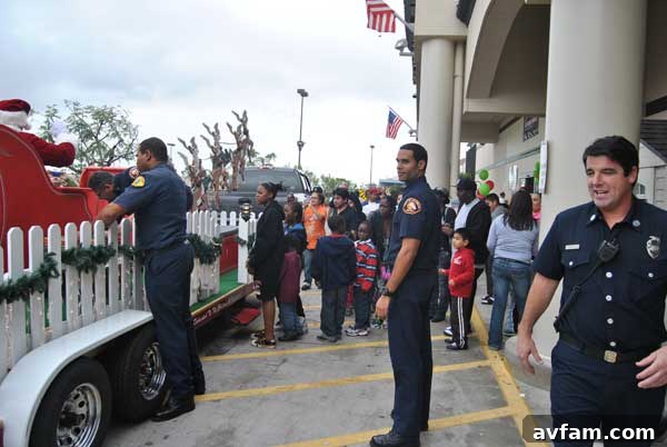 Children excitedly line up at Home Depot, awaiting Santa's arrival at the community fire safety event.