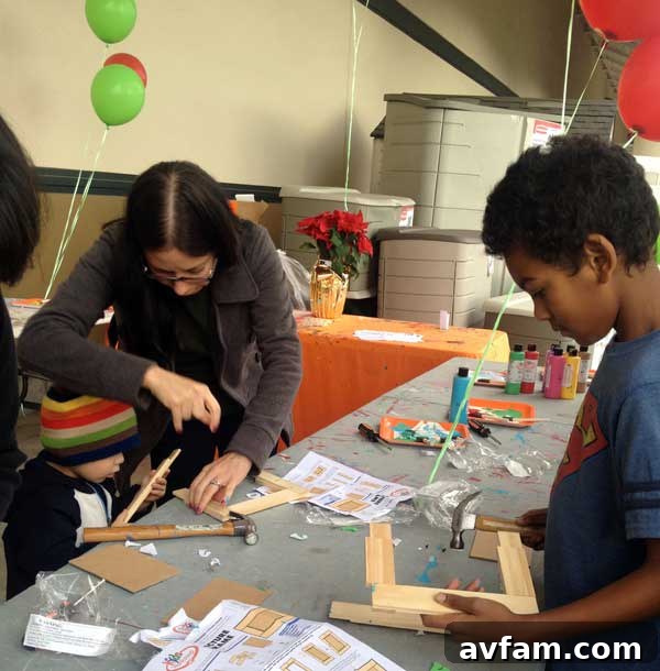 A view of the bustling Home Depot Kids Workshop, where children are actively involved in building and decorating projects.