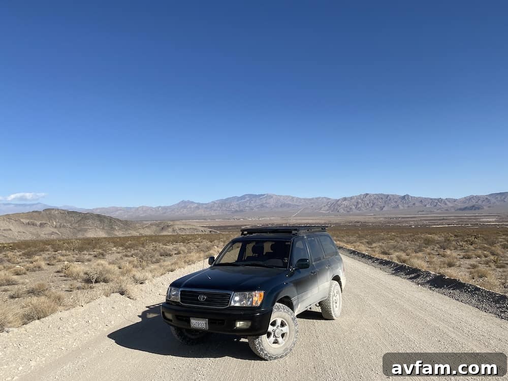 Toyota Land Cruiser 100 Series parked on a dirt road at sunset